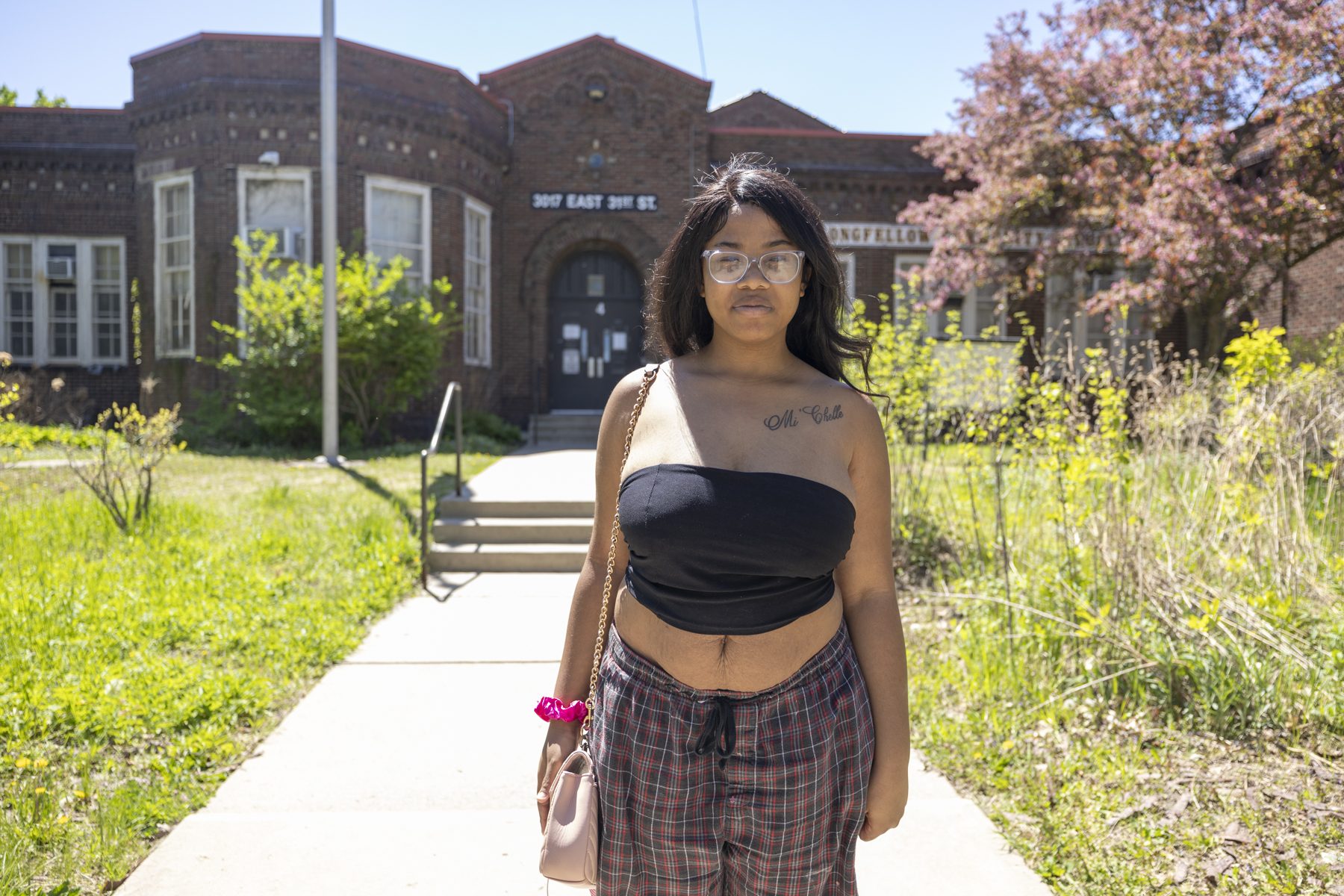 Promise, 16, a Longfellow student, standing on the front walk of the school